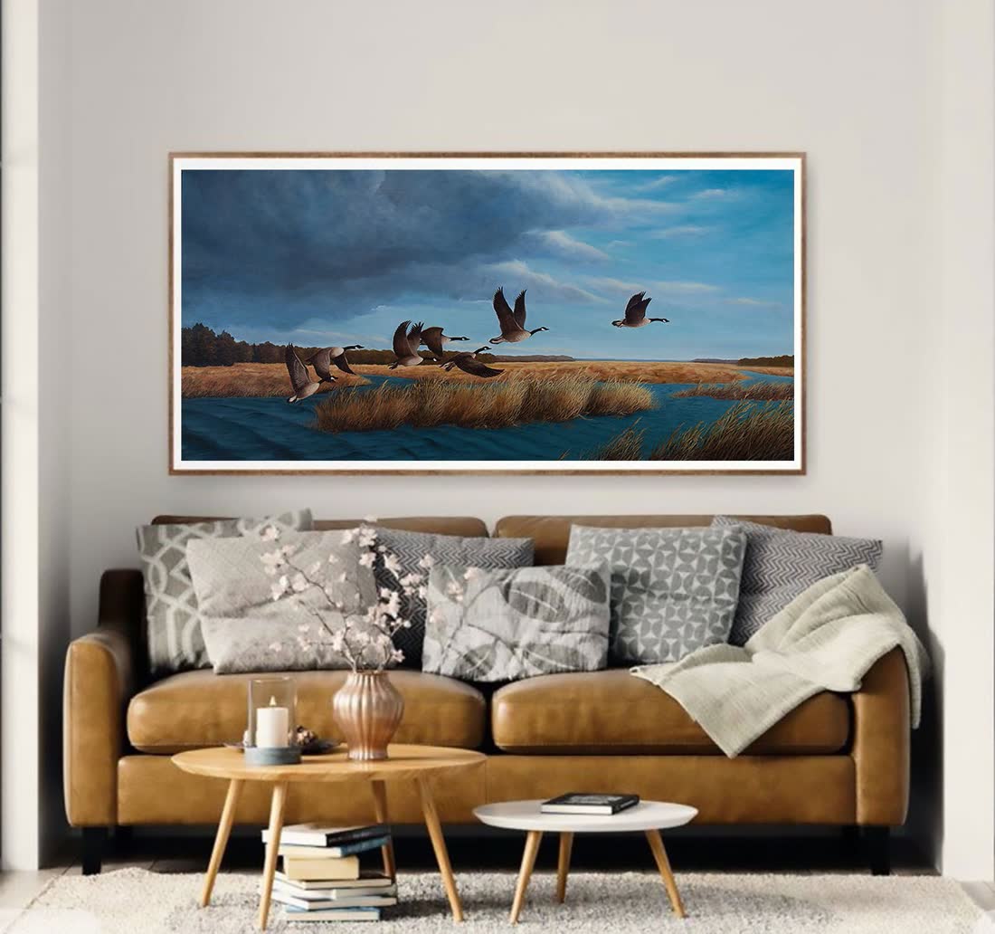 An original Bill Langis geese painting hung in a furnished room