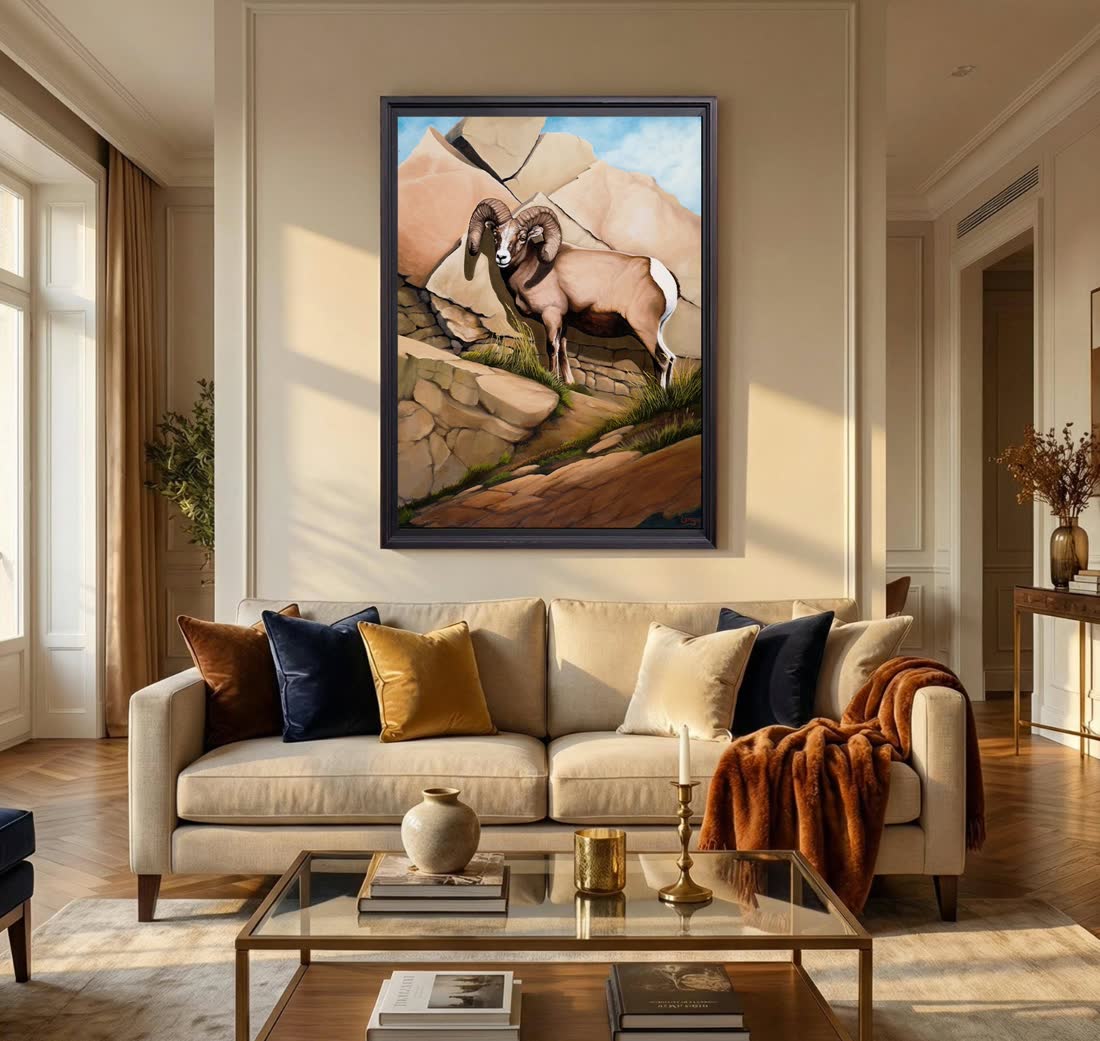 An original Bill Langis bighorn painting hung in a furnished room